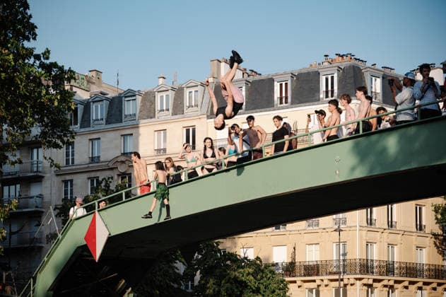Parisians Swim In The Canal Saint-Martin To Escape The Heatwave A man performs a backflip from a bridge over the Canal Saint-Martin in Paris, France, on June 26, 2026, as Parisians swim to cool off during a heatwave that has placed the capital under a red alert. Paris France  Copyright: xSamuelxBoivinx originalFilename: boivin-notitle260626_npLnQ.jpg