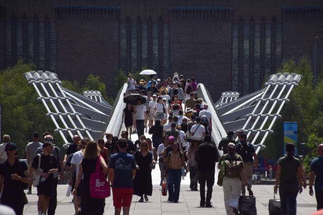 June 27, 2026, London, England, United Kingdom: People walk across Millennium Bridge, some carrying umbrellas, as the heatwave continues in UK and Europe. London United Kingdom - ZUMAv130 20260627_zip_v130_013 Copyright: xVukxValcicx