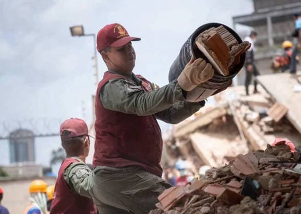 Volunteers and rescue workers gather on the rubble of collapsed buildings during rescue operations following the devastating earthquake across wide areas, in La Guaira, Venezuela, on June 26, 2026. photo by Government Ministry of Information (Venezuela)  VAN2026062627 GovernmentxMinistryxofxInformati