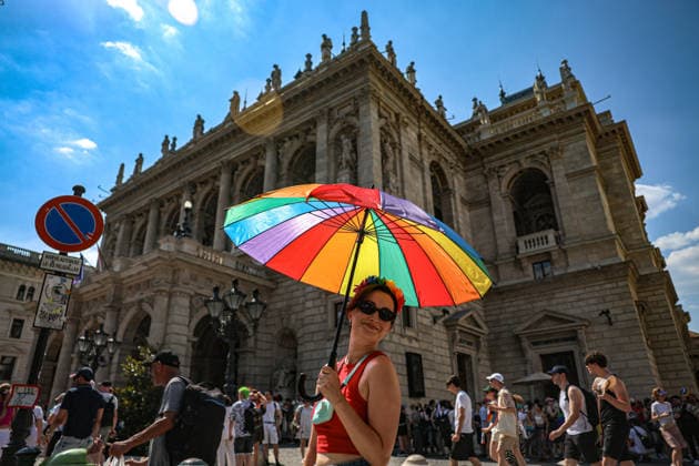 June 27, 2026, Budapest, Hungary, European Union: A woman with a rainbow umbrella and a flower in her hair in front of the Opera House smiles at the camera during Budapest Pride, the first Pride march held since HungaryÃ¢â‚¬â ¢s April 2026 parliamentary election. The annual event brought together LGBTQ+ people, allies and supporters calling for equality, visibility and acceptance. Budapest European Union  - ZUMAo116 20260627_znp_o116_069 Copyright: xBiancaxOterox