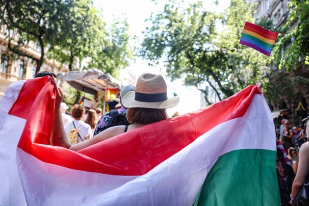 June 27, 2026, Budapest, Hungary, European Union: A woman wears a Hungarian flag as a cape while waving the pride flag during Budapest Pride, the first Pride march held since HungaryÃ¢â‚¬â ¢s April 2026 parliamentary election. The annual event brought together LGBTQ+ people, allies and supporters calling for equality, visibility and acceptance. Budapest European Union  - ZUMAo116 20260627_znp_o116_072 Copyright: xBiancaxOterox