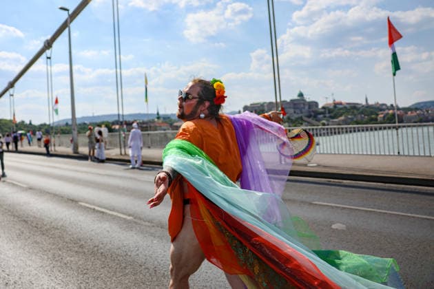 June 27, 2026, Budapest, Hungary, European Union: A young man wearing a rainbow floral crown, sunglasses and a rainbow cape runs through the crowd with his arms open on Elizabeth Bridge during Budapest Pride, with Buda Castle visible across the Danube. The march was the first held since HungaryÃ¢â‚¬â ¢s April 2026 parliamentary election. Budapest European Union  - ZUMAo116 20260627_znp_o116_075 Copyright: xBiancaxOterox