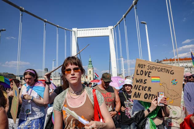 June 27, 2026, Budapest, Hungary, European Union: Marchers carrying rainbow and transgender pride flags move beneath the arches of Elizabeth Bridge during Budapest Pride, while a participant holds a sign reading, -Not Supporting Love Was Never an Option.- The march was the first held since HungaryÃ¢â‚¬â ¢s April 2026 parliamentary election. Budapest European Union  - ZUMAo116 20260627_znp_o116_081 Copyright: xBiancaxOterox