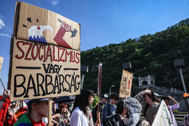 June 27, 2026, Budapest, Hungary, European Union: A person holds the sign Szocializmus vagy Barbarsag, meaning Socialism or Barbarism in Hungary while walking across the Elizabeth Bridge and the Gellert Hill in background, during Budapest Pride, the first Pride march held since HungaryÃ¢â‚¬â ¢s April 2026 parliamentary election. The annual event brought together LGBTQ+ people, allies and supporters calling for equality, visibility and acceptance. Budapest European Union  - ZUMAo116 20260627_znp_o116_087 Copyright: xBiancaxOterox