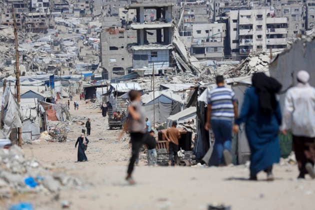 Jabalia Gaza Daily Life Palestinian residents walk along a road lined with makeshift shelters and rubble in Jabalia, northern Gaza Strip on June 27, 2026. Residents remain among the ruins of damaged and destroyed buildings in Jabalia, where access to basic services such as water, electricity, and shelter remains severely limited. Gaza Gaza Strip Palestinian Territories Copyright: xAhmedxAlxArinix