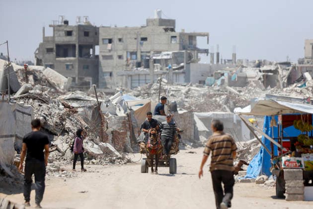 Jabalia Gaza Daily Life Palestinian residents walk along a road lined with rubble and damaged buildings in Jabalia, northern Gaza Strip on June 27, 2026. Residents remain among the ruins of damaged and destroyed buildings in Jabalia, where access to basic services such as water, electricity, and shelter remains severely limited. Gaza Gaza Strip Palestinian Territories Copyright: xAhmedxAlxArinix
