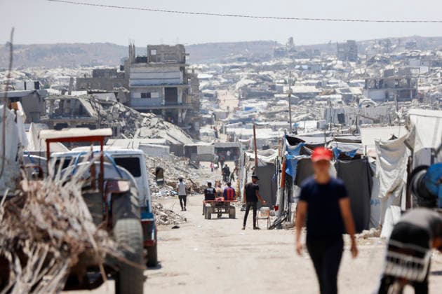 Jabalia Gaza Daily Life Palestinian residents walk along a road lined with makeshift shelters and rubble in Jabalia, northern Gaza Strip on June 27, 2026. Residents remain among the ruins of damaged and destroyed buildings in Jabalia, where access to basic services such as water, electricity, and shelter remains severely limited. Gaza Gaza Strip Palestinian Territories Copyright: xAhmedxAlxArinix