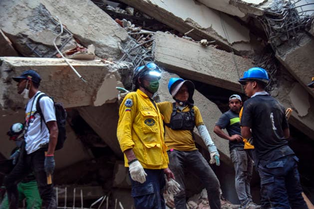 Members of Caracas firefighters search for victims amid debris of a demolished building after a magnitude 7.2 earthquake struck Venezuela and other regions in the Caribbean in La Guaira, Venezuela, on June 27, 2026. According to the U.S. Geological Survey, a powerful 7.5?magnitude aftershock struck after the main quake. Medical and media sources reported that the death toll has risen to around 1,500, with some 3,000 others injured. A web page created to track the missing has listed nearly 50,000 people as unaccounted for. photo by Jonathan Lanza  VAN2026062807 JonathanxLanza