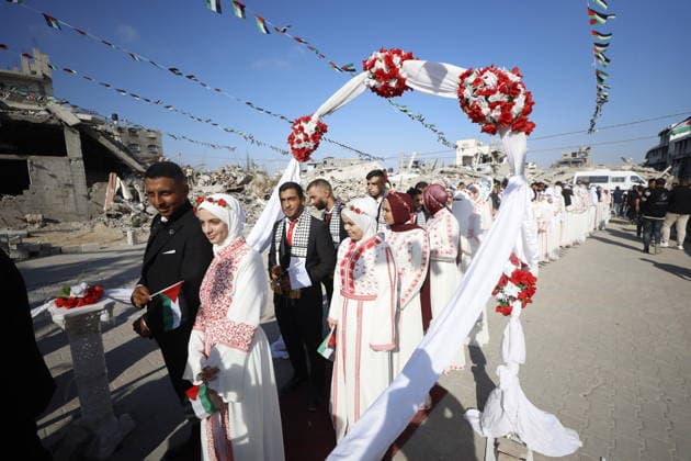 150 Palestinian couples tie the knot in mass wedding at Jabalia Camp GAZA, PALESTINE - JUNE 28: Newlyweds celebrate as 150 Palestinian couples tie the knot in a mass wedding ceremony organized by a charity organization at the Jabalia Refugee Camp in the northern Gaza Strip, Gaza, Palestine on June 28, 2026. The young couples advanced towards the wedding hall accompanied by traditional songs and dances. Ahmed Jihad Ibrahim Al-arini Anadolu Gaza City Gaza. Editorial use only. Please get in touch for any other usage.  Copyright: x2026xAnadoluxAhmedxJihadxIbrahimxAl-arinix
