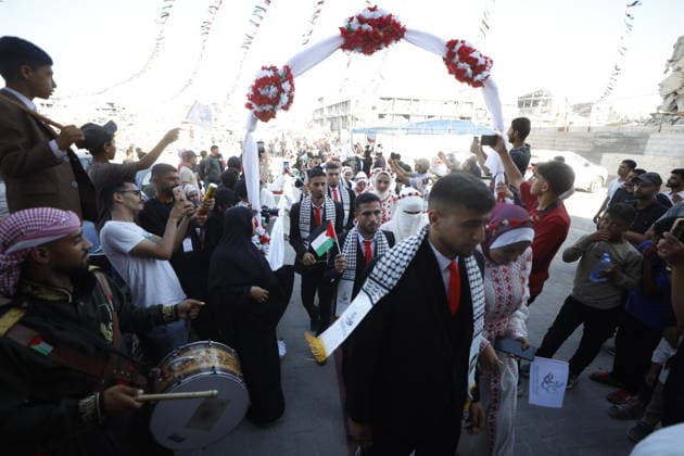 150 Palestinian couples tie the knot in mass wedding at Jabalia Camp GAZA, PALESTINE - JUNE 28: Newlyweds celebrate as 150 Palestinian couples tie the knot in a mass wedding ceremony organized by a charity organization at the Jabalia Refugee Camp in the northern Gaza Strip, Gaza, Palestine on June 28, 2026. The young couples advanced towards the wedding hall accompanied by traditional songs and dances. Ahmed Jihad Ibrahim Al-arini Anadolu Gaza City Gaza. Editorial use only. Please get in touch for any other usage.  Copyright: x2026xAnadoluxAhmedxJihadxIbrahimxAl-arinix