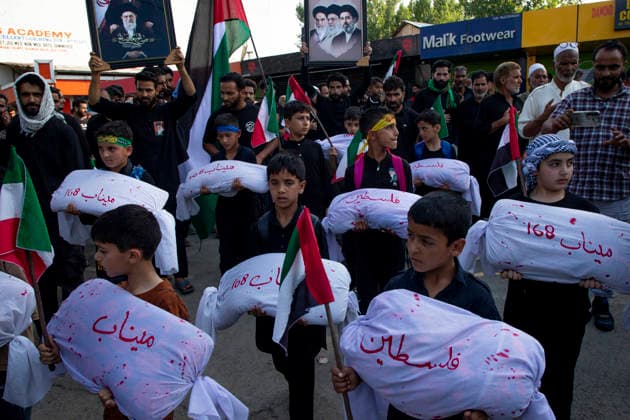 June 28, 2026, Srinagar, Jammu And Kashmir, India: Shiite Muslim children carry shrouded replicas symbolizing the children killed in the Israeli and US strikes on Minab School in Iran during a religious procession on the 12th day of the Islamic month of Muharram, expressing solidarity with the victims, in the outskirts of Srinagar, Indian administered Kashmir. Muharram, the first month of the Islamic calendar, is observed by Shiite Muslims around the world in remembrance of Imam Hussain, the grandson of the Prophet Muhammad, who was killed along with members of his family and companions in the Battle of Karbala in present day Iraq in 680 AD. Srinagar India - ZUMAs197 20260628_aaa_s197_055 Copyright: xFaisalxBashirx