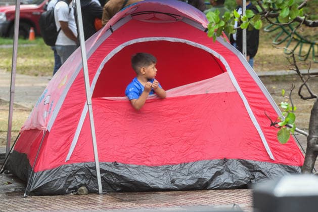 (260629) -- CARACAS, June 29, 2026 -- A boy stays in a tent on a square in Caracas, Venezuela, June 28, 2026. Venezuelan National Assembly President Jorge Rodriguez said Sunday that the death toll from two powerful earthquakes that struck Venezuela Wednesday has risen to 1,450. (Photo by Xinhua) (SpotNews) VENEZUELA-CARACAS-EARTHQUAKE-AFTERMATH MarcosxSalgado 