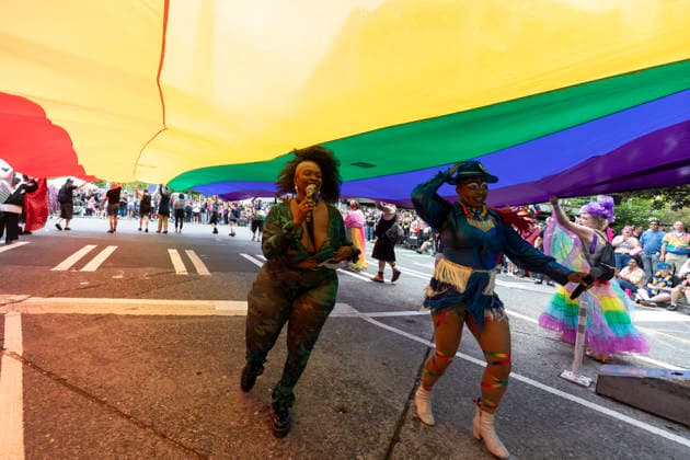 June 28, 2026, Seattle, Washington, USA: Parade hosts Goddess Briq House (Left) and DJ MIXX America run under a large pride flag during the Seattle Pride Parade in SeattleÃ¢â‚¬â ¢s Belltown on Sunday, June 28, 2026. Seattle USA - ZUMAg235 20260628_zap_g235_030 Copyright: xPaulxChristianxGordonx