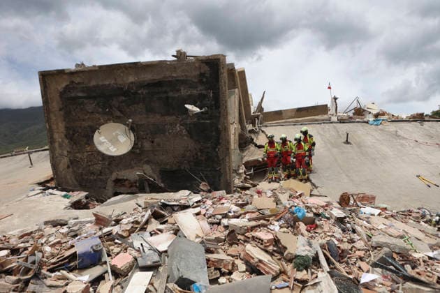 (260629) -- LA GUAIRA, June 29, 2026 -- Rescuers work on a collapsed building in Playa Grande, La Guaira state, Venezuela, June 28, 2026. Venezuelan National Assembly President Jorge Rodriguez said Sunday that the death toll from two powerful earthquakes that uck Venezuela Wednesday has risen to 1,450. ( Xinhua) (SpotNews) VENEZUELA-LA GUAIRA-EARTHQUAKES-DEATH TOLL STR 