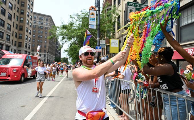 June 28, 2026, Chicago, Illinois, USA: BLAKE WOHLWEND interacts with the crowd by letting them touch his pride themed decoration towards the end of the parade route on Sunday June 28th, 2026 in Chicago, Illinois. Chicago USA - ZUMAd171 20260628_znp_d171_011 Copyright: xSethxDonovanx