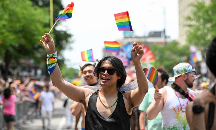 June 28, 2026, Chicago, Illinois, USA: PHIL POSCUA waves two pride flags as he marches the parade route on Sunday June 28th, 2026. Chicago USA - ZUMAd171 20260628_znp_d171_017 Copyright: xSethxDonovanx
