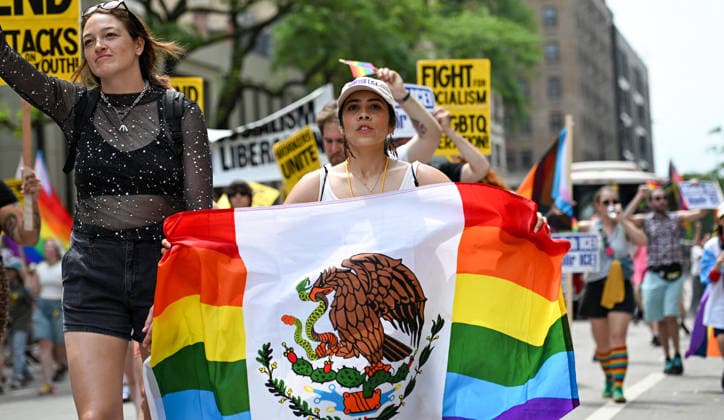 June 28, 2026, Chicago, Illinois, USA: A woman holds up a pride themed Mexican flag while marching down the street during the annual Chicago pride parade on Sunday June 28th, 2026. Chicago USA - ZUMAd171 20260628_znp_d171_018 Copyright: xSethxDonovanx