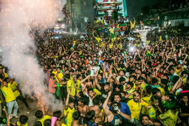 June 30, 2026, Dhaka, Munshiganj, Bangladesh: Thousands of Brazilian football supporters flood the Supermarket Chottor in Munshiganj, Bangladesh, on the night of June 29, 2026, as Brazil secured a 2-1 victory over Japan in the FIFA World Cup 2026 group stage. Despite heavy rain, the crowd Ã¢â‚¬ draped in yellow jerseys and waving green-and-gold flags Ã¢â‚¬ packed every inch of the square, climbing monument structures and rooftops to catch a glimpse of the giant screen. The atmosphere shifted from tense silence to explosive celebration as the final whistle blew, with smoke flares, fireworks, and thousands of raised hands marking one of the most electric football nights in the town s recent memory. Bangladesh has no team in the World Cu  - ZUMAa259 20260630_zip_a259_007 Copyright: xRayhanxAhmedx