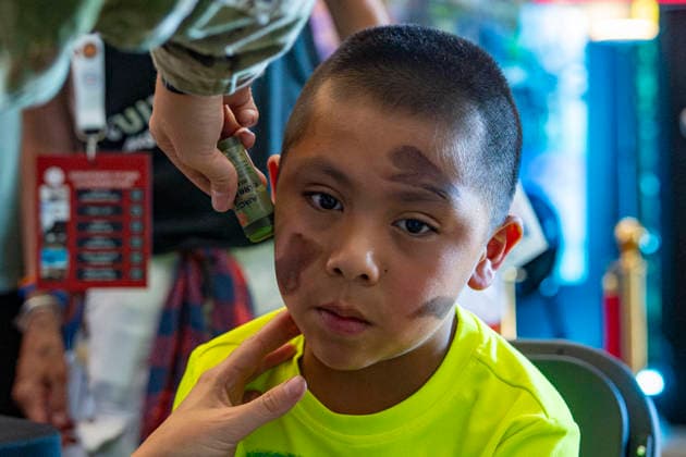 A boy has his face painted in camouflage colors in the department of War exhibit during the fifth day of the Great American State Fair on the National Mall on Monday, June 29, 2026. The Freedom 250-backed Great American State Fair celebrating the 250th anniversary of the United States runs through July 10th.  WAP20260629404 BONNIExCASH