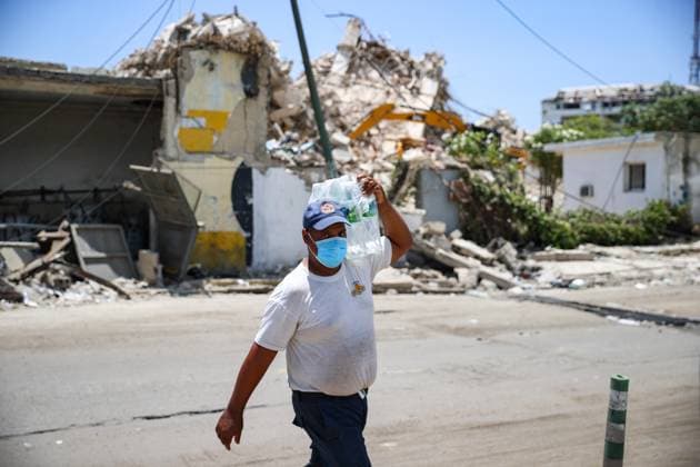 Search and rescue operations continue in Earthquake-hit Venezuela GUAIRA, VENEZUELA - JUNE 29: People walk past debris of collapsed buildings following powerful earthquakes in La Guaira, Venezuela on June 29, 2026. Cem Tekkesinoglu Anadolu La Guaira Venezuela. Editorial use only. Please get in touch for any other usage.  Copyright: x2026xAnadoluxCemxTekkesinoglux