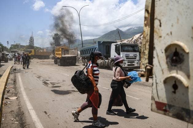 Search and rescue operations continue in Earthquake-hit Venezuela GUAIRA, VENEZUELA - JUNE 29: People walk past trucks and heavy machinery during debris removal efforts following powerful earthquakes in La Guaira, Venezuela on June 29, 2026. Cem Tekkesinoglu Anadolu La Guaira Venezuela. Editorial use only. Please get in touch for any other usage.  Copyright: x2026xAnadoluxCemxTekkesinoglux