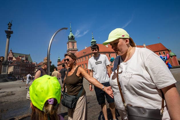 June 27, 2026, Warsaw, Mazovia, Poland: Varsovians enjoy the relief of a cooling misting station near the Royal Castle. On the afternoon of the 28th of June, Varsovians cool and hydrate themselves around the city during a record-breaking heatwave. Due to the extreme heat, the authorities provided misting sprays and water tanks around the city. During the weekend, Warsaw experienced temperatures approaching 38Â°C as the unprecedented European heatwave swept across Poland, roughly 15Â°C above the late-June average. Tropical nights, nationwide heat alerts, and temperatures up to 40.5Â°C elsewhere in the country made this one of the most extreme heat events in modern Polish history. Warsaw Poland - ZUMAs197 20260627_aaa_s197_329 Copyright: xNeilxMiltonx
