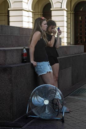 June 27, 2026, Warsaw, Mazovia, Poland: Standing next to a large electric fan, a girl applies make-up. On the afternoon of the 28th of June, Varsovians cool and hydrate themselves around the city during a record-breaking heatwave. Due to the extreme heat, the authorities provided misting sprays and water tanks around the city. During the weekend, Warsaw experienced temperatures approaching 38Â°C as the unprecedented European heatwave swept across Poland, roughly 15Â°C above the late-June average. Tropical nights, nationwide heat alerts, and temperatures up to 40.5Â°C elsewhere in the country made this one of the most extreme heat events in modern Polish history. Warsaw Poland - ZUMAs197 20260627_aaa_s197_350 Copyright: xNeilxMiltonx