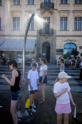 June 27, 2026, Warsaw, Mazovia, Poland: Young children enjoy the relief of a cooling misting station. On the afternoon of the 28th of June, Varsovians cool and hydrate themselves around the city during a record-breaking heatwave. Due to the extreme heat, the authorities provided misting sprays and water tanks around the city. During the weekend, Warsaw experienced temperatures approaching 38Â°C as the unprecedented European heatwave swept across Poland, roughly 15Â°C above the late-June average. Tropical nights, nationwide heat alerts, and temperatures up to 40.5Â°C elsewhere in the country made this one of the most extreme heat events in modern Polish history. Warsaw Poland - ZUMAs197 20260627_aaa_s197_353 Copyright: xNeilxMiltonx