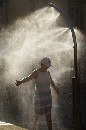 June 27, 2026, Warsaw, Mazovia, Poland: A lady enjoys the relief of a cooling misting station. On the afternoon of the 28th of June, Varsovians cool and hydrate themselves around the city during a record-breaking heatwave. Due to the extreme heat, the authorities provided misting sprays and water tanks around the city. During the weekend, Warsaw experienced temperatures approaching 38Â°C as the unprecedented European heatwave swept across Poland, roughly 15Â°C above the late-June average. Tropical nights, nationwide heat alerts, and temperatures up to 40.5Â°C elsewhere in the country made this one of the most extreme heat events in modern Polish history. Warsaw Poland - ZUMAs197 20260627_aaa_s197_356 Copyright: xNeilxMiltonx