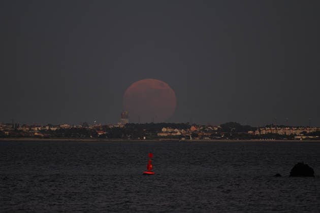 June 29, 2026, Lisbon, Portugal: The moon is seen rising over the Tagus River in Lisbon. Strawberry Supermoon is a term derived from the traditions of the North American indigenous peoples, who called this moon by that name because it coincided with the wild strawberry harvest season. Lisbon Portugal - ZUMAs197 20260629_aaa_s197_067 Copyright: xJorgexCastellanosx