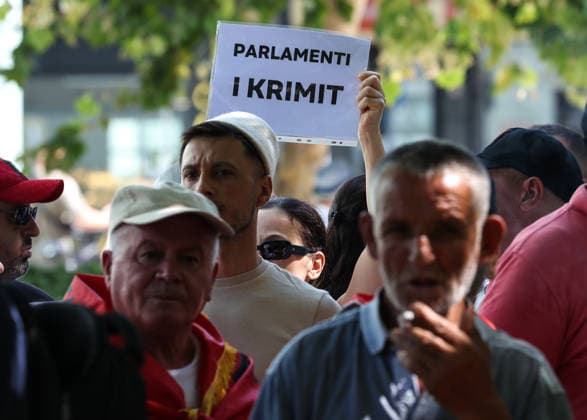 June 30, 2026, Tirana, Tirana, Albania: Protesters shout anti Government slogans as hold a sign reading Parliament of Crime during a protest in front of Albanian Parliament asking resignation of Albanian Prime Minister Edi Rama and of his Government here in Tirana, Albania, on 30 June 2026. Tirana Albania - ZUMAb266 20260630_zip_b266_003 Copyright: xArmandoxBabanix