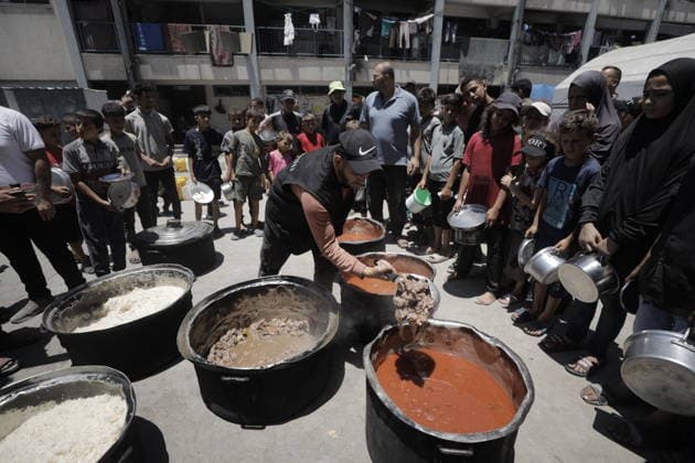 Hot meals distributed to Palestinians in Gaza GAZA CITY, GAZA, PALESTINE - JUNE 30: Hot meals are being distributed at a school sheltering Palestinians in the Rimal neighborhood, west of Gaza City, Gaza, Palestine, on June 30, 2026. Food shortages continue in the Gaza Strip due to Israel’s blockade and restrictions on the entry of humanitarian aid. Large crowds, including many children, gathered at the distribution point to receive hot meals. Ahmed Jihad Ibrahim Al-arini Anadolu Gaza City Gaza. Editorial use only. Please get in touch for any other usage.  Copyright: x2026xAnadoluxAhmedxJihadxIbrahimxAl-arinix