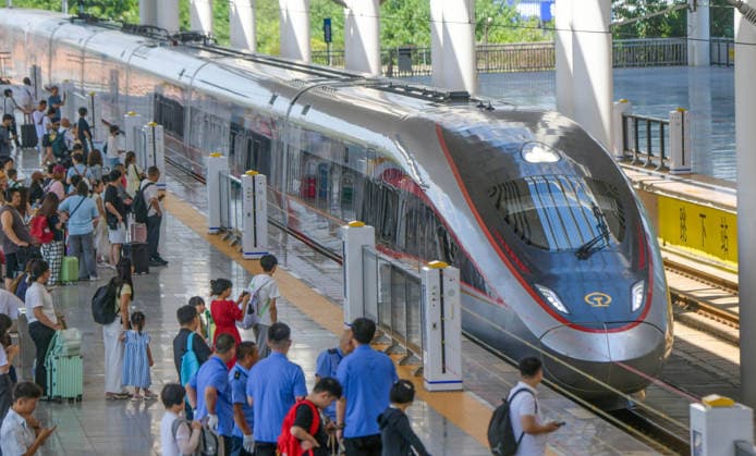 LUOYANG, CHINA - JULY 01: Passengers board a Fuxing bullet train at Luoyang Longmen Station on July 1, 2026 in Luoyang, Henan Province of China. The railway network has implemented a new train schedule to kick off the summer transport season.  Copyright: xVCGx 111651582412