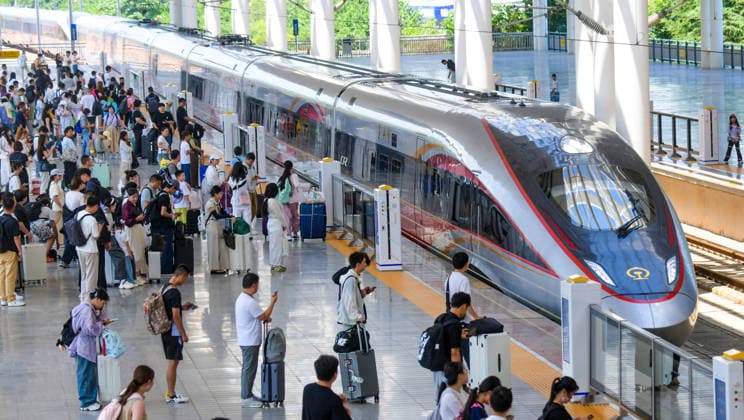 LUOYANG, CHINA - JULY 01: Passengers board a Fuxing bullet train at Luoyang Longmen Station on July 1, 2026 in Luoyang, Henan Province of China. The railway network has implemented a new train schedule to kick off the summer transport season.  Copyright: xVCGx 111651582416