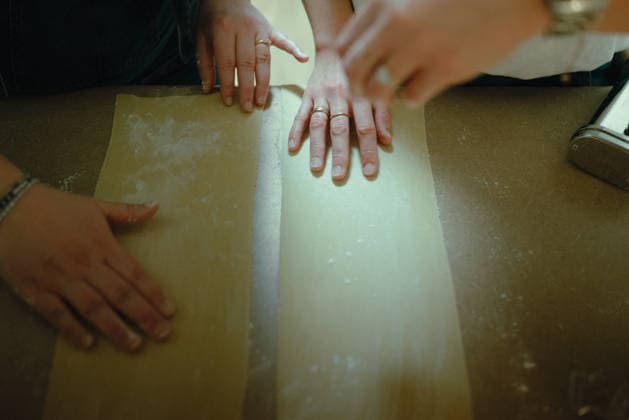 Several hands preparing fresh homemade pasta dough San Diego, California, United States R_QCYJ260625-2032431-01