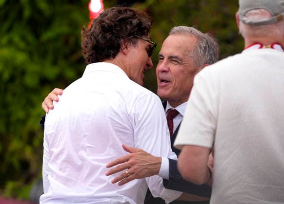 July 1, 2026, Ottawa, On, CAN: Prime Minister Mark Carney embraces former prime minister Justin Trudeau after at the Canada Day National noon ceremony at LeBreton Flats in Ottawa, on Wednesday, July 1, 2026. Ottawa CAN  - ZUMAc35_ 20260701_zaf_c35_143 Copyright: xJustinxTangx