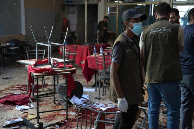 Damascus Cafe Blast Aftermath Investigated A forensic investigator wearing gloves walks through the damaged interior of a cafe in central Damascus, Syria, on July 2, 2026. An explosive device detonated inside the cafe near the Palace of Justice in the al-Hijaz area, killing people and injuring others, Syrian authorities said. Damascus Damascus Syria Copyright: xOmarxAlbamx