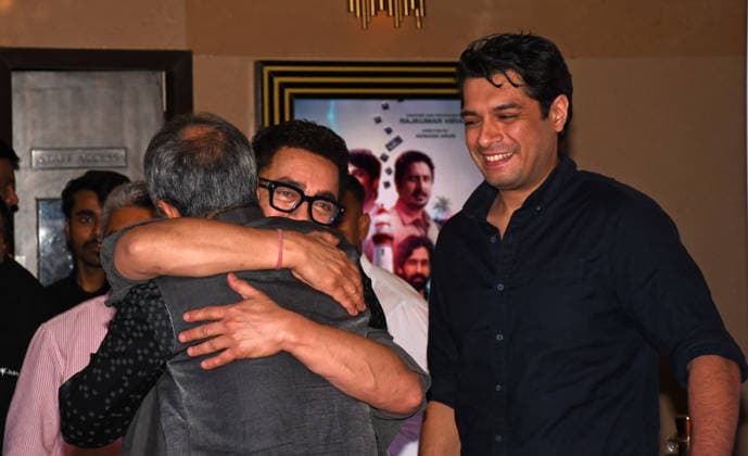 July 2, 2026, Mumbai, Maharashtra, India: Bollywood actor Aamir Khan (L) hugs filmmaker Rajkumar Hirani as actor Junaid Khan (R) looks on at the screening of web series Pritam & Pedro in Mumbai. Mumbai India - ZUMAs197 20260702_aaa_s197_207 Copyright: xAshishxVaishnavx