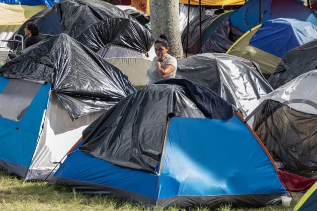Earthquake-displaced families take shelter in an open-door temporary facility in Caracas CARACAS, VENEZUELA - JULY 2: A woman is seen among tents as dozens of families displaced by the twin earthquakes that struck the country are finding a place to sleep, eat, and take shelter while trying to decide what to do next after losing their homes in Caracas, Venezuela, on July 2, 2026. It is an open-door temporary shelter: arrivals can stay for a night or several days, and are free to leave to look for relatives or try to resolve their situation. Around 500 families are currently settled in this shelter. Most come from various devastated areas of the capital, though families have also arrived from La Guaira, the hardest-hit state, which was declar  Copyright: x2026xAnadoluxDikoxBetancourtx