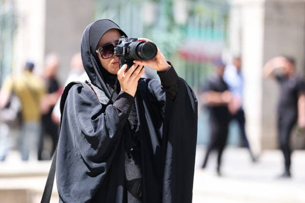 IRAN, TEHRAN - JULY 3, 2026: A woman journalist take pictures on the eve of the state funeral of Supreme Leader Ali Khamenei (1939-2026) set to take place from July 4 to 9. Khamenei was killed in a joint US-Israeli airstrike on his residence on February 28. Valery Sharifulin TASS  94604201