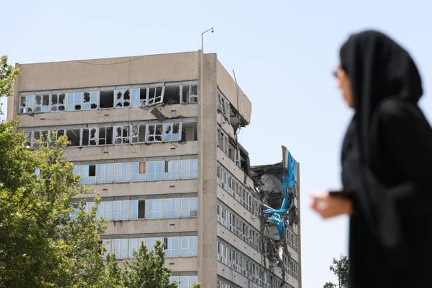 IRAN, TEHRAN - JULY 3, 2026: A woman walks past a damaged local government building on the eve of the state funeral of Supreme Leader Ali Khamenei (1939-2026) set to take place from July 4 to 9. Khamenei was killed in a joint US-Israeli airstrike on his residence on February 28. Valery Sharifulin TASS  94604619