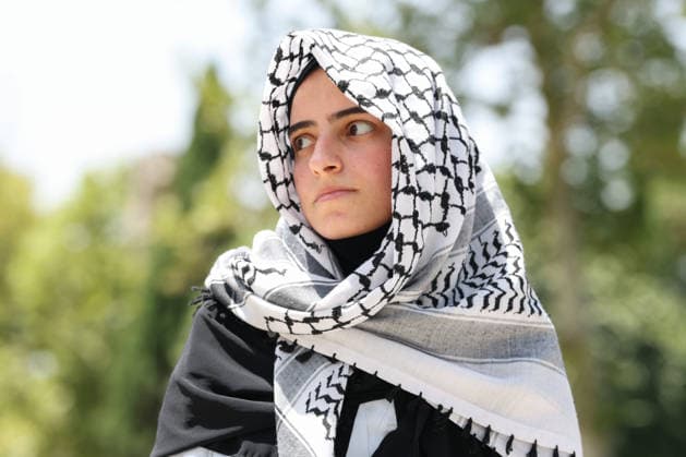 IRAN, TEHRAN - JULY 3, 2026: A woman wears a keffiyeh headdress on the eve of the state funeral of Supreme Leader Ali Khamenei (1939-2026) set to take place from July 4 to 9. Khamenei was killed in a joint US-Israeli airstrike on his residence on February 28 Tehran Iran  - ZUMAt113 20260703_zaa_t113_024 Copyright: xValeryxSharifulinx