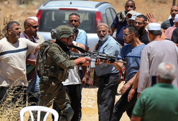 Israeli soldiers intervene against Palestinians performing Islamic Friday prayer BETHLEHEM, WEST BANK, PALESTINE - JULY 03: An Israeli soldier holds a Palestinian man at gunpoint as Israeli soldiers intervene with stun grenades and tear gas against Palestinians performing Friday prayers during a raid on the village of Abu Nujaym, near Bethlehem in West Bank, Palestine on July 03, 2026. Tensions erupted between several Palestinian residents and Israeli soldiers. Wisam Hashlamoun Anadolu Bethlehem West Bank. Editorial use only. Please get in touch for any other usage.  Copyright: x2026xAnadoluxWisamxHashlamounx