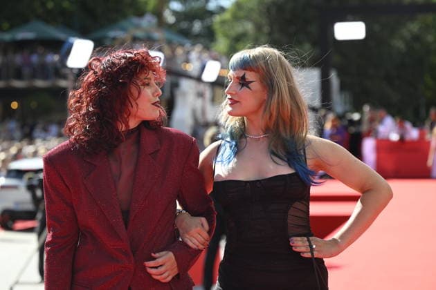 Czech singer Aiko, right, arrives at the opening of the 60th Karlovy Vary International Film Festival, on June 3, 2026, in Karlovy Vary, Czech Republic. (CTKxPhoto KaterinaxSulova) CTKPhotoP2026070306423  CTKPhotoP2026070306423
