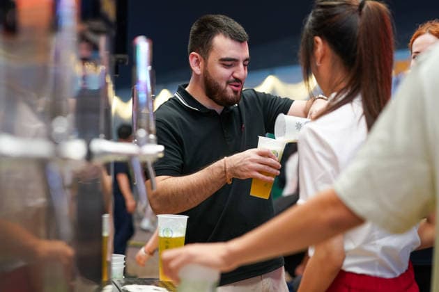 HARBIN, CHINA - JULY 03: A foreign tourist pours beer at the Beer Exchange during the opening of the 24th Harbin International Beer Festival on July 3, 2026 in Harbin, Heilongjiang Province of China. The festival features eight functional zones including five beer tents and 11 international beer gardens.  Copyright: xChinaxNewsxServicex 111652053463