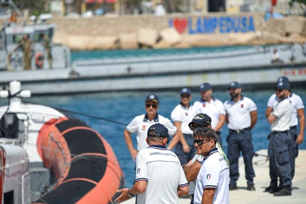 Daily life in Lampedusa before the arrival of Pope Leo XIV LAMPEDUSA, ITALY - JULY 3: Members of the Italian Coast Guard stand beside a patrol boat at Favaloro Pier ahead of Pope Leo XIV s visit to Lampedusa on July 4, as local residents, security forces and NGOs prepare to welcome the pontiff while tourists and locals continue their daily summer activities in Lampedusa, Italy, on July 3, 2026. Valeria Ferraro Anadolu Lampedusa Italy. Editorial use only. Please get in touch for any other usage.  Copyright: x2026xAnadoluxValeriaxFerrarox