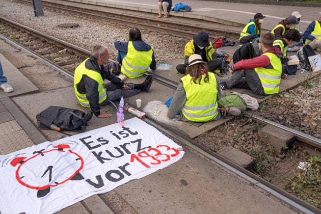 Sitzblockade, Demonstranten blockieren Stadtbahn-Schienen, die zum Messegelände führen, Protest gegen den AfD-Bundesparteitag an diesem Wochenende in Erfurt, 4. Juli 2026 Deutschland, Erfurt, 4. Juli 2026, Sitzblockade, Demonstranten blockieren Stadtbahn-Schienen, die zum Messegelände führen, Stadtbahn hat den Betrieb im Umfeld des Messegeländes schon seit gestern abgestellt, Protest gegen den AfD-Bundesparteitag an diesem Wochenende in Erfurt, Protestbewegung, Politik, Thüringen *** Sit-in protest; demonstrators are blocking the light rail tracks leading to the convention center; protest against the AfD national party convention taking place this weekend in Erfurt, July 4, 2026; Germany, Erfurt, July 4, 2026, Sit-in blockade; protest