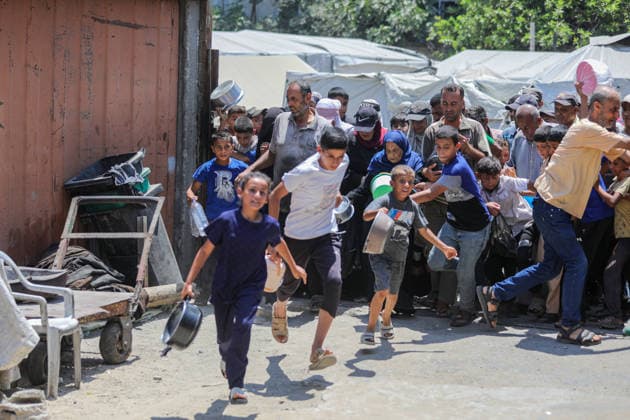 Hot meals distributed to Palestinians in Gaza under Israeli attacks NUSEIRAT, GAZA, PALESTINE - JULY 4: Palestinians, including children, rush toward a food distribution point carrying empty pots and containers in the Nuseirat refugee camp in central Gaza on July 4, 2026. Food shortages continue across the Gaza Strip as Israeli blockade and restrictions on the entry of humanitarian aid persist. Hassan Jedi Anadolu Nuseirat Gaza. Editorial use only. Please get in touch for any other usage.  Copyright: x2026xAnadoluxHassanxJedix