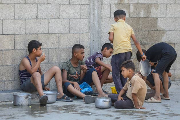 Hot meals distributed to Palestinians in Gaza under Israeli attacks NUSEIRAT, GAZA, PALESTINE - JULY 4: Palestinians, including children, gather after receiving hot meals at a food distribution point in the Nuseirat refugee camp in central Gaza on July 4, 2026. Food shortages continue across the Gaza Strip as Israeli blockade and restrictions on the entry of humanitarian aid persist. Hassan Jedi Anadolu Nuseirat Gaza. Editorial use only. Please get in touch for any other usage.  Copyright: x2026xAnadoluxHassanxJedix