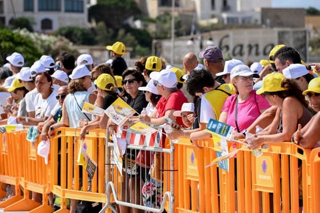 Pope Leo XIV visits the Southern Italian island of Lampedusa LAMPEDUSA, ITALY - JULY 04: People seen weaiving flags in Lampedusa, Italy, on July 04, 2026. Pope Leo XIV arrived in Lampedusa to rise attention to the migrant issue and the unique position of the island. During his visit he met with a group of migrants, accompanied by the Red Cross at Favaloro Pier, inaugurating a new plaque with the new name of the Pier dedicated to Pope Francis. Later nearly 4000 people gathered in the sport field to attend the homily celebrated by the Pope. Valeria Ferraro Anadolu Lampedusa Italy. Editorial use only. Please get in touch for any other usage.  Copyright: x2026xAnadoluxValeriaxFerrarox